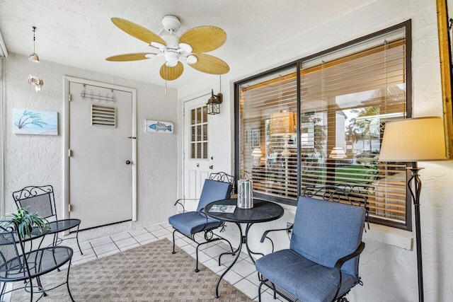 sunroom / solarium featuring ceiling fan