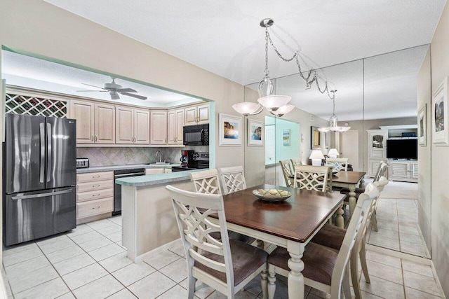 dining room featuring light tile patterned floors, sink, and ceiling fan