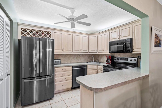 kitchen with sink, tasteful backsplash, light tile patterned floors, kitchen peninsula, and black appliances