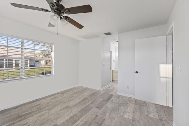 unfurnished room with light wood-type flooring and ceiling fan