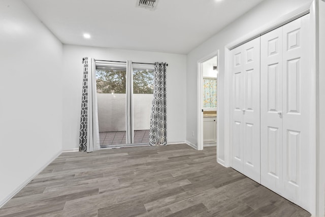 spare room with wood-type flooring