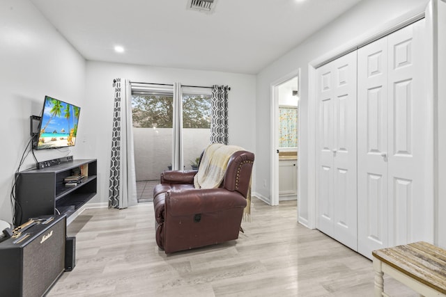 sitting room featuring light hardwood / wood-style flooring