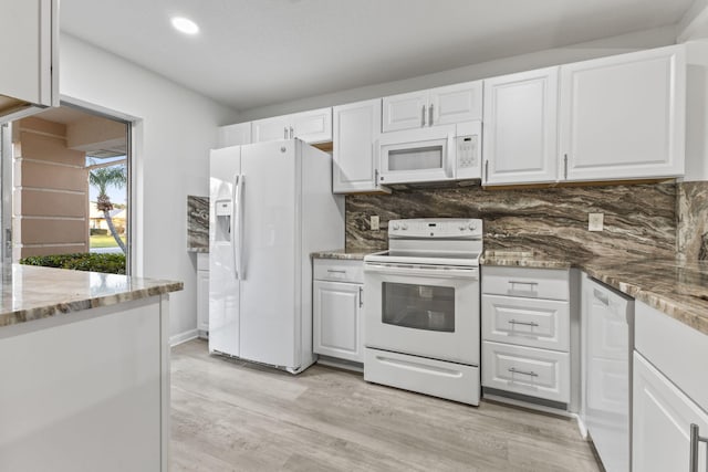 kitchen with white appliances, light wood-type flooring, stone counters, white cabinetry, and tasteful backsplash