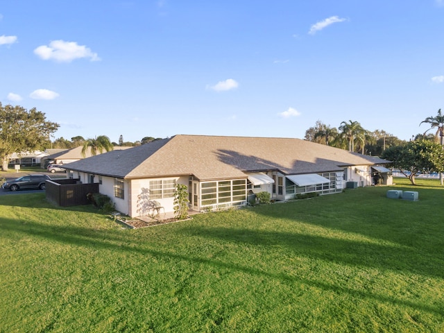 back of house with a lawn