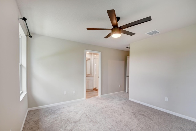 unfurnished room featuring light carpet and ceiling fan