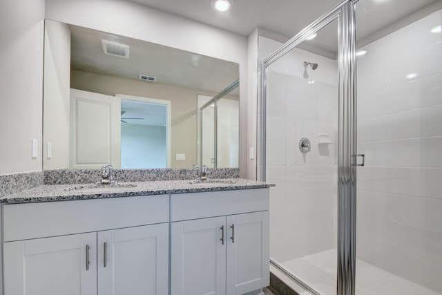 bathroom with vanity, ceiling fan, and an enclosed shower