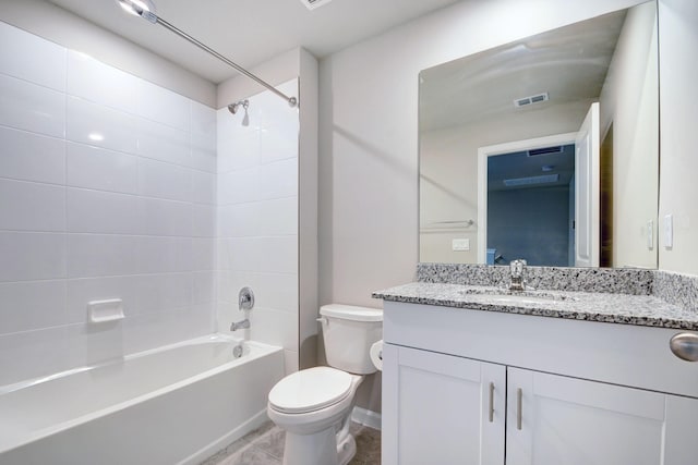 full bathroom featuring vanity, tiled shower / bath combo, and toilet