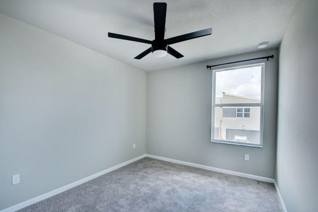 unfurnished room featuring ceiling fan, carpet floors, and a textured ceiling