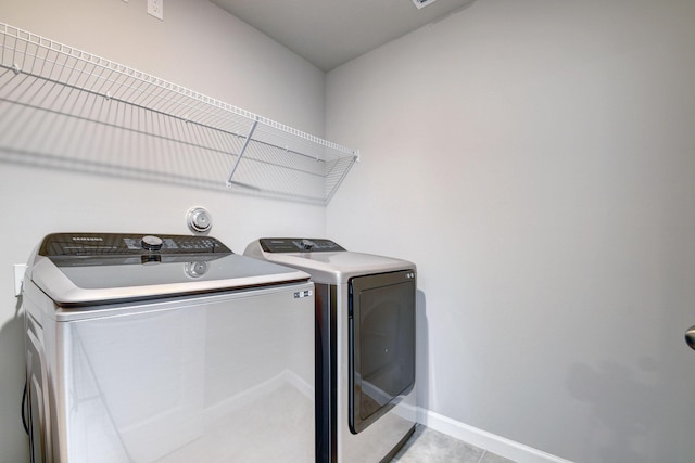 laundry room featuring light tile patterned floors and independent washer and dryer