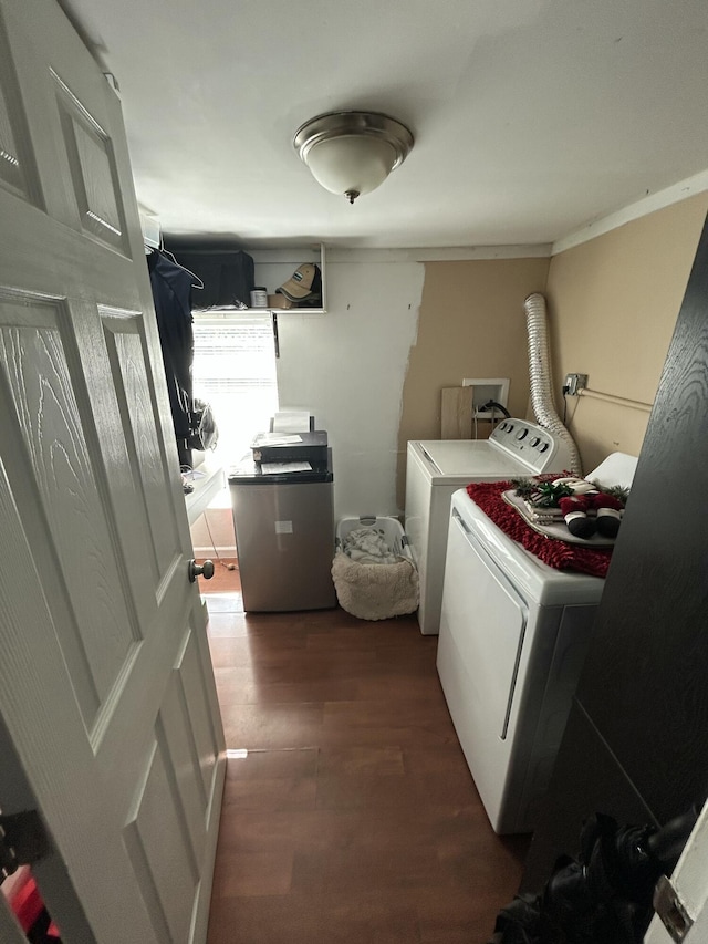 laundry area featuring washer and clothes dryer and dark hardwood / wood-style floors