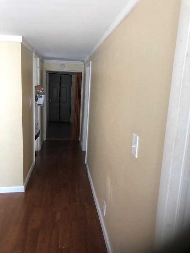 hall featuring dark wood-type flooring and ornamental molding