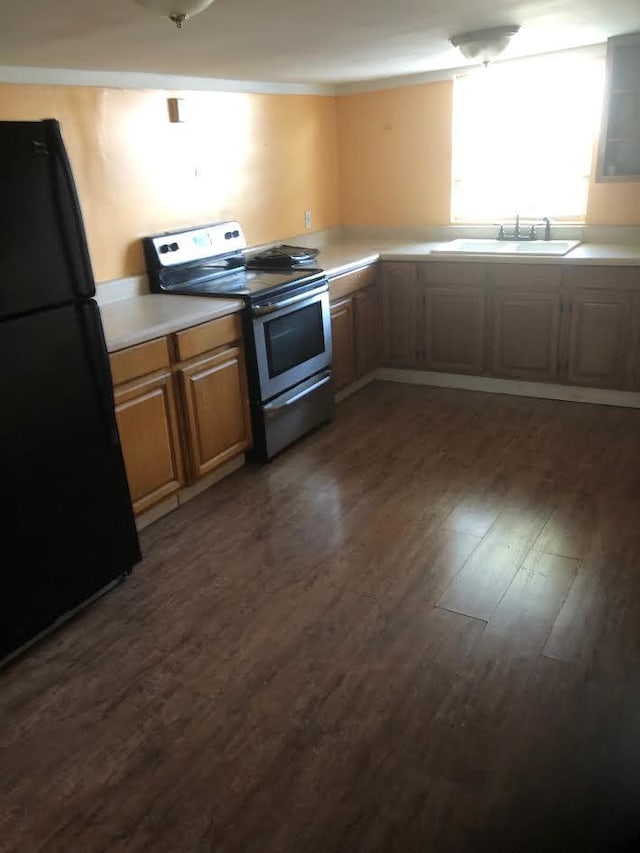 kitchen with black refrigerator, electric range, dark hardwood / wood-style floors, and sink