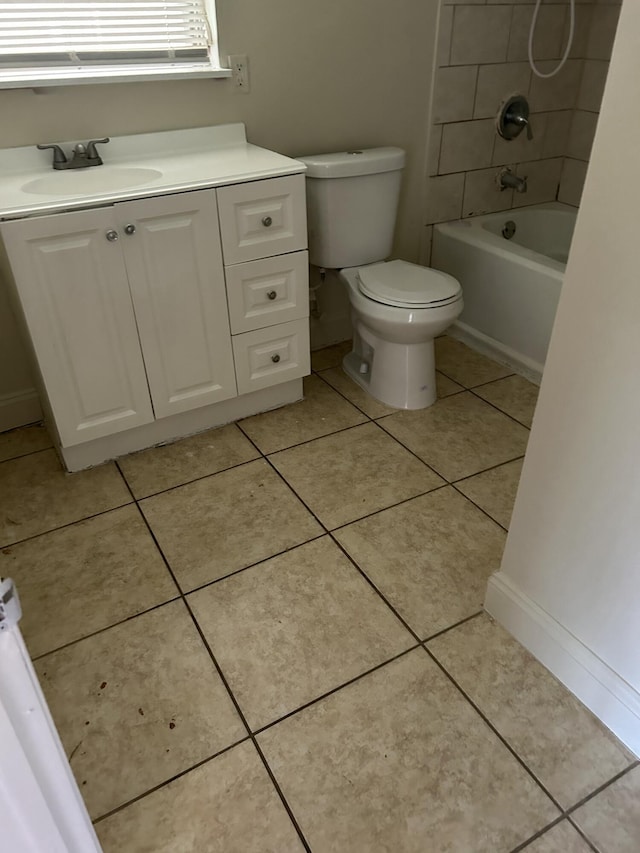 full bathroom with toilet, tile patterned flooring, tiled shower / bath, and vanity