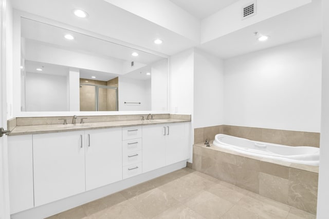 bathroom featuring vanity and shower with separate bathtub