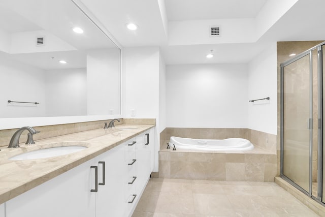 bathroom featuring tile patterned floors, vanity, and shower with separate bathtub