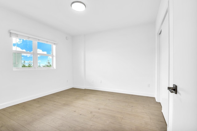 unfurnished bedroom with connected bathroom and light hardwood / wood-style floors