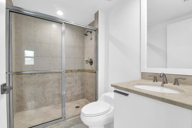 bathroom featuring toilet, vanity, an enclosed shower, and tile patterned floors