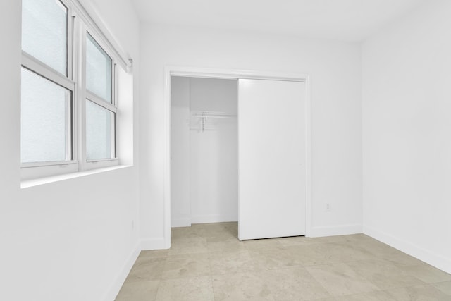 unfurnished bedroom with a closet