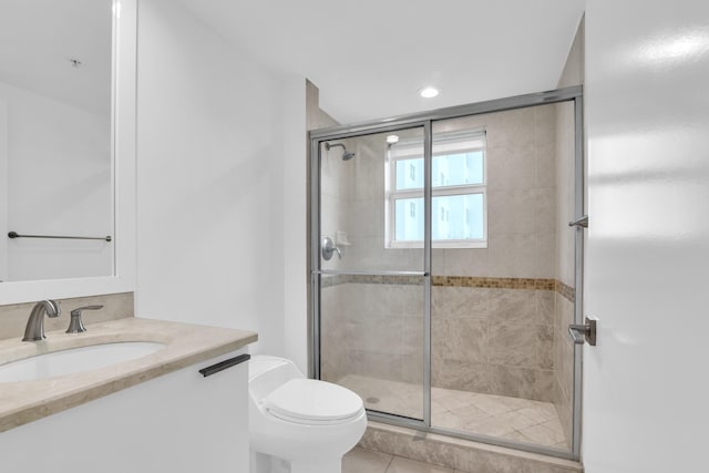 bathroom with toilet, tile patterned flooring, an enclosed shower, and vanity