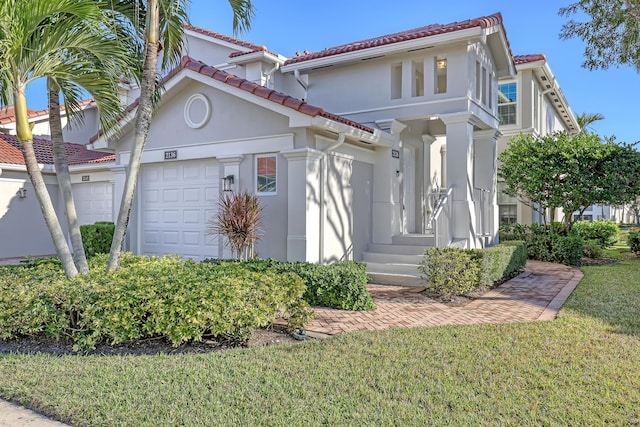 view of front of property featuring a front yard and a garage