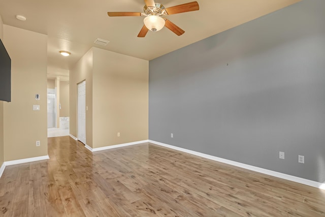 empty room with light wood-type flooring and ceiling fan