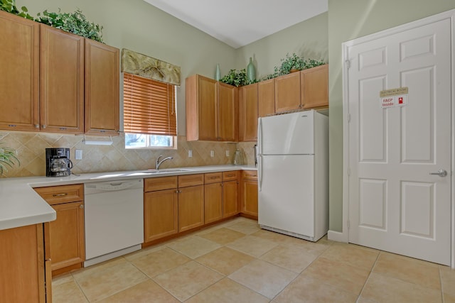 kitchen featuring sink, white appliances, light tile patterned floors, and tasteful backsplash