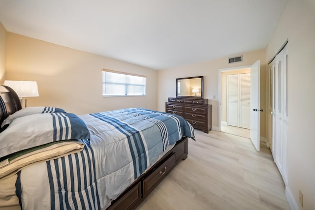 bedroom featuring light wood-type flooring and a closet