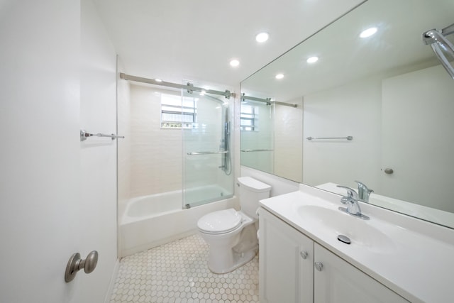 full bathroom featuring vanity, toilet, and combined bath / shower with glass door