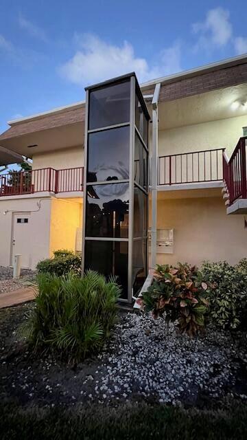 view of side of property with a balcony