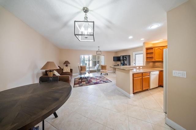 kitchen featuring kitchen peninsula, light tile patterned flooring, white dishwasher, and pendant lighting