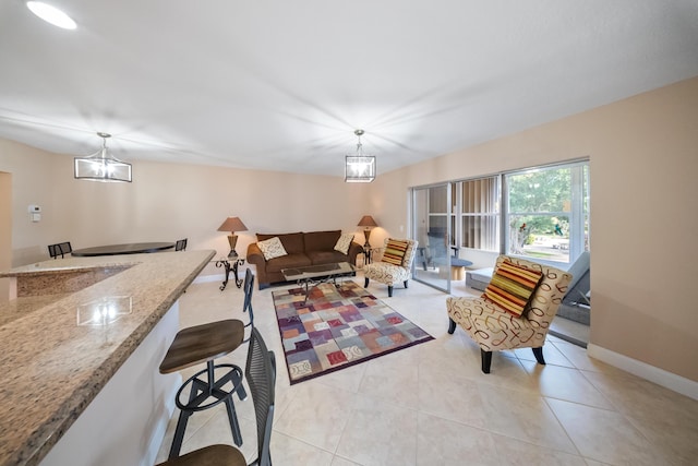 living room featuring a notable chandelier and light tile patterned flooring