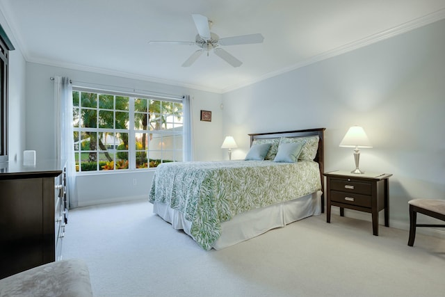 bedroom with light carpet, ceiling fan, and crown molding