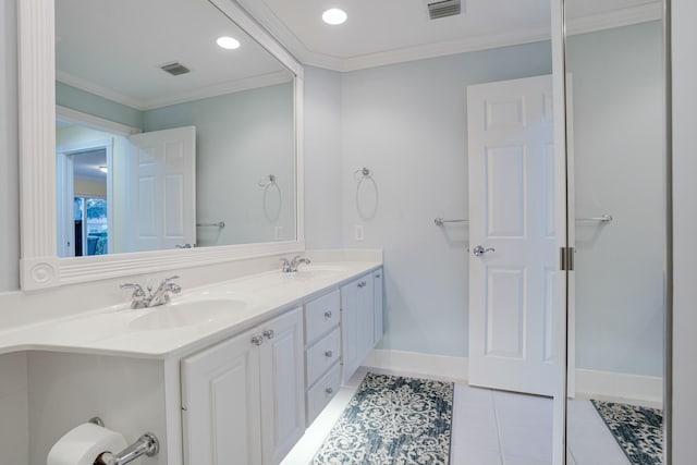 bathroom featuring tile patterned flooring, vanity, and crown molding