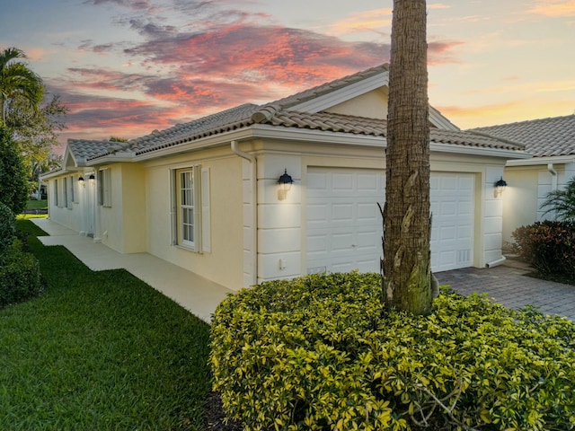 property exterior at dusk with a garage