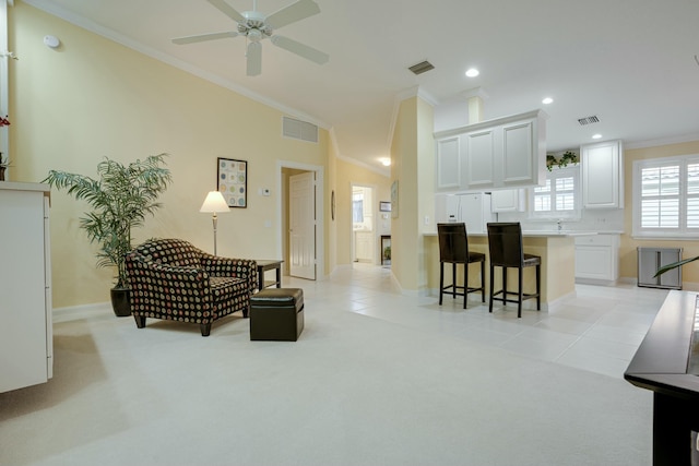 carpeted living room featuring ceiling fan and crown molding