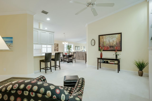 carpeted living room with ceiling fan with notable chandelier and ornamental molding