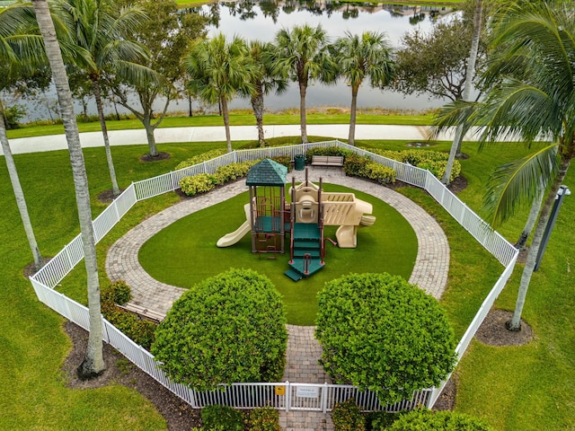 view of home's community featuring a playground, a yard, and a water view