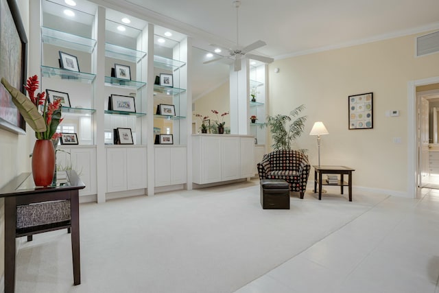 living area with carpet, ceiling fan, and crown molding