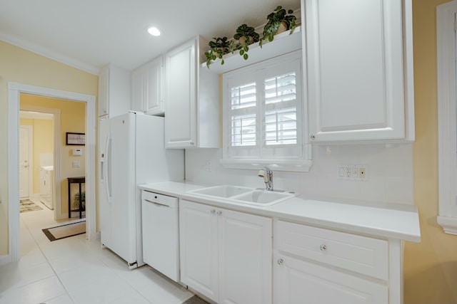 kitchen featuring white cabinetry, sink, light tile patterned floors, and white appliances