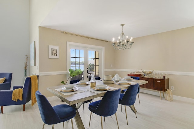 dining area featuring french doors and an inviting chandelier