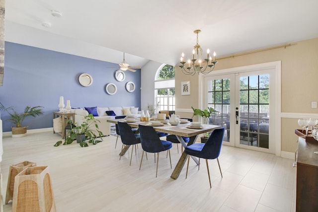 dining room featuring french doors, ceiling fan with notable chandelier, and vaulted ceiling