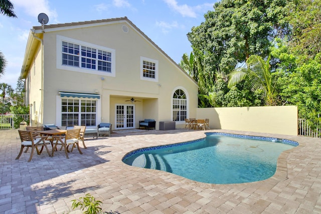 view of pool featuring a patio area and french doors