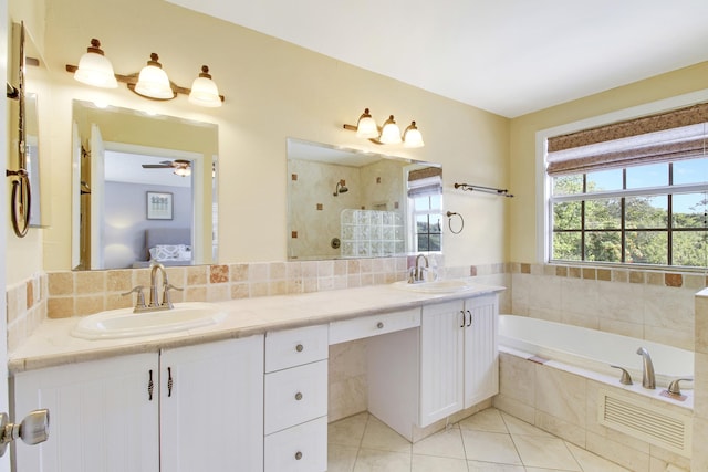 bathroom featuring ceiling fan, tile patterned flooring, vanity, and shower with separate bathtub