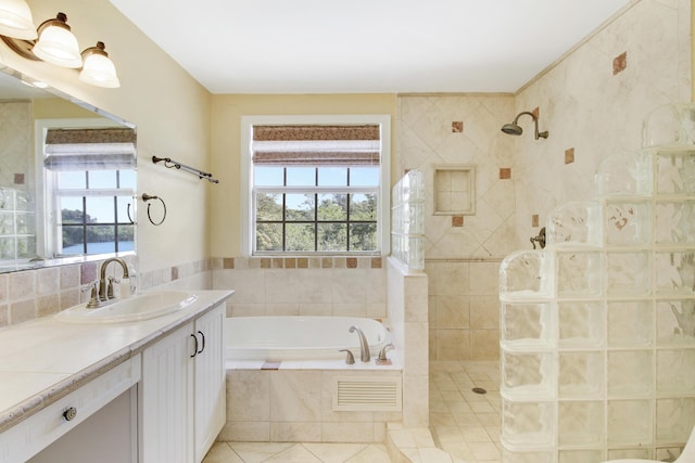 bathroom featuring plus walk in shower, tile patterned flooring, and vanity