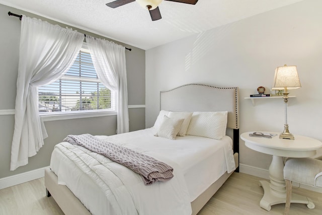 bedroom featuring ceiling fan and light hardwood / wood-style flooring