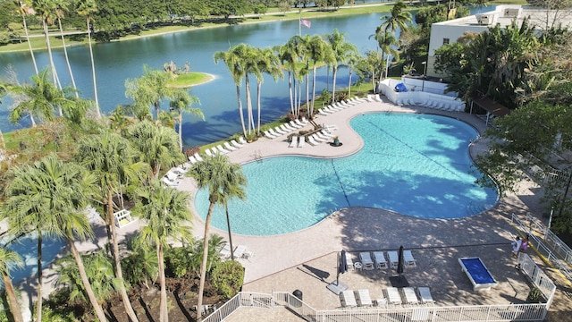 view of swimming pool with a water view and a patio