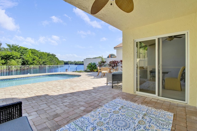 view of pool with ceiling fan and a patio