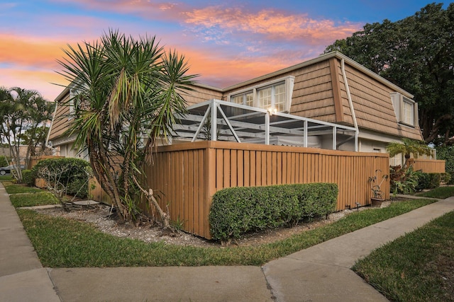 property exterior at dusk with a lanai