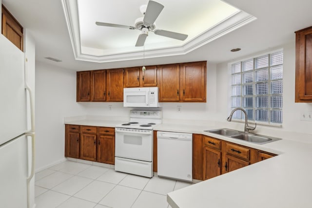 kitchen with white appliances, sink, a raised ceiling, ceiling fan, and light tile patterned floors