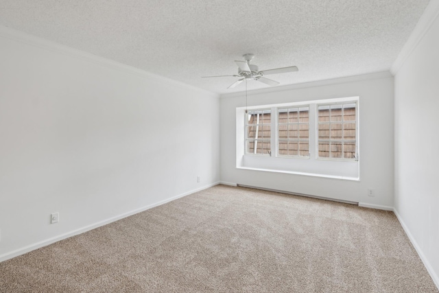 carpeted spare room featuring a textured ceiling, ceiling fan, and crown molding